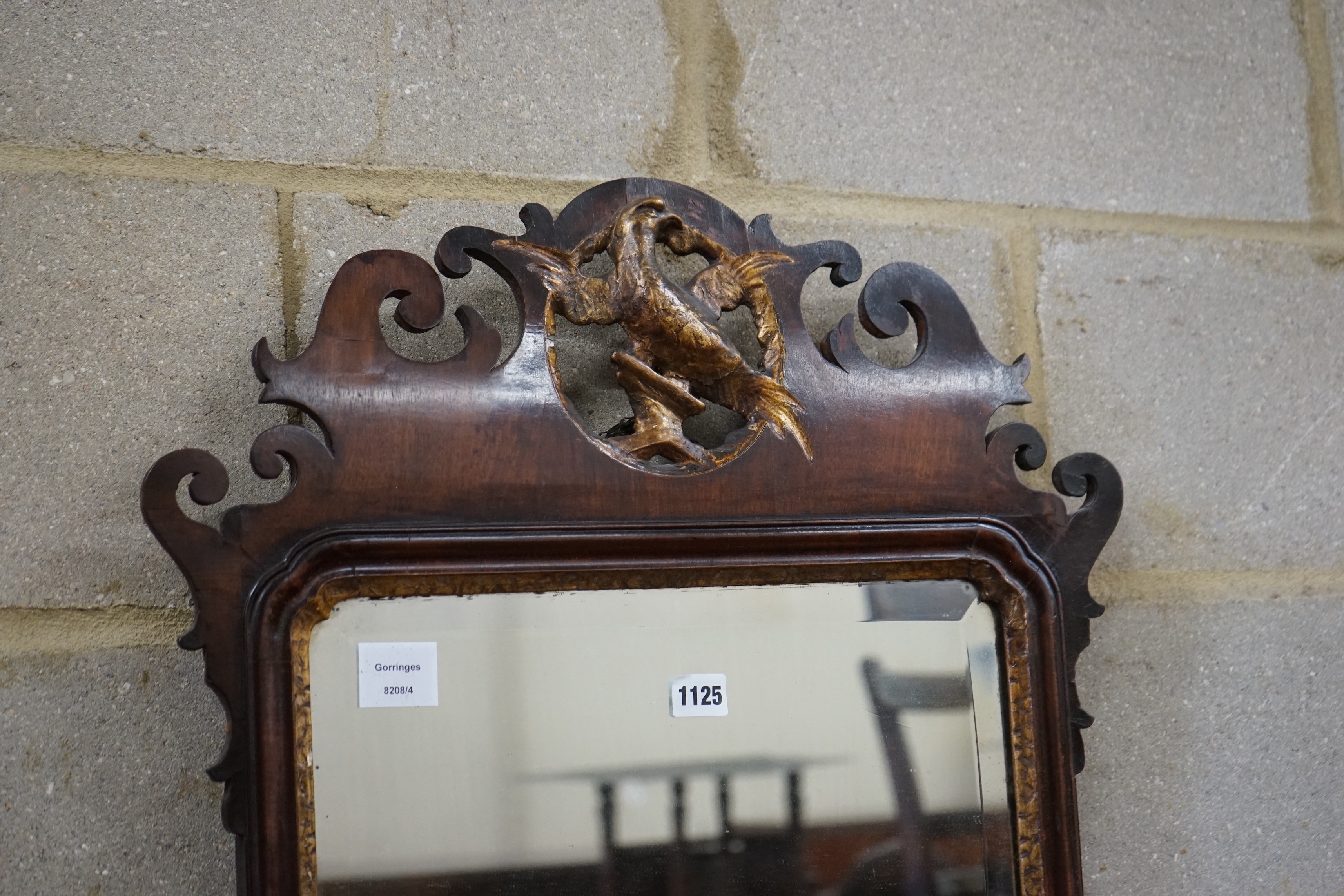 A George III style mahogany fret cut wall mirror, with gilt carved eagle surmount, width 56cm, height 108cm